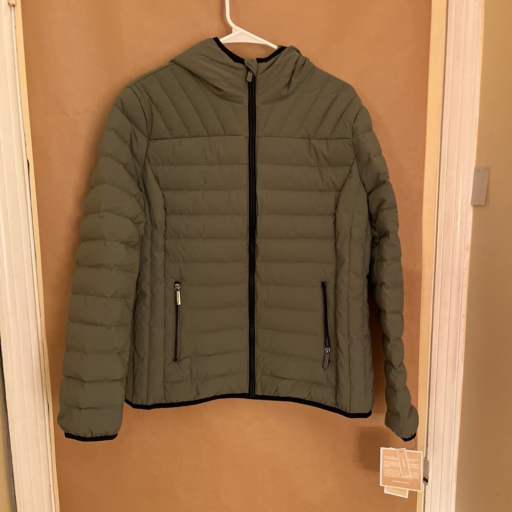 Puffy Down Jacket. Light sage green with black accents. Full zip with hood.